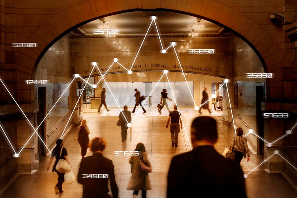 Pessoas andando em uma estação de metrô e linhas passando entre eles fazendo associação com a cultura data driven